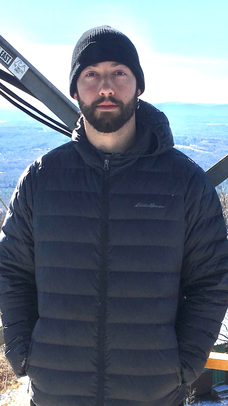 An image of Harrison on top of a mountain.